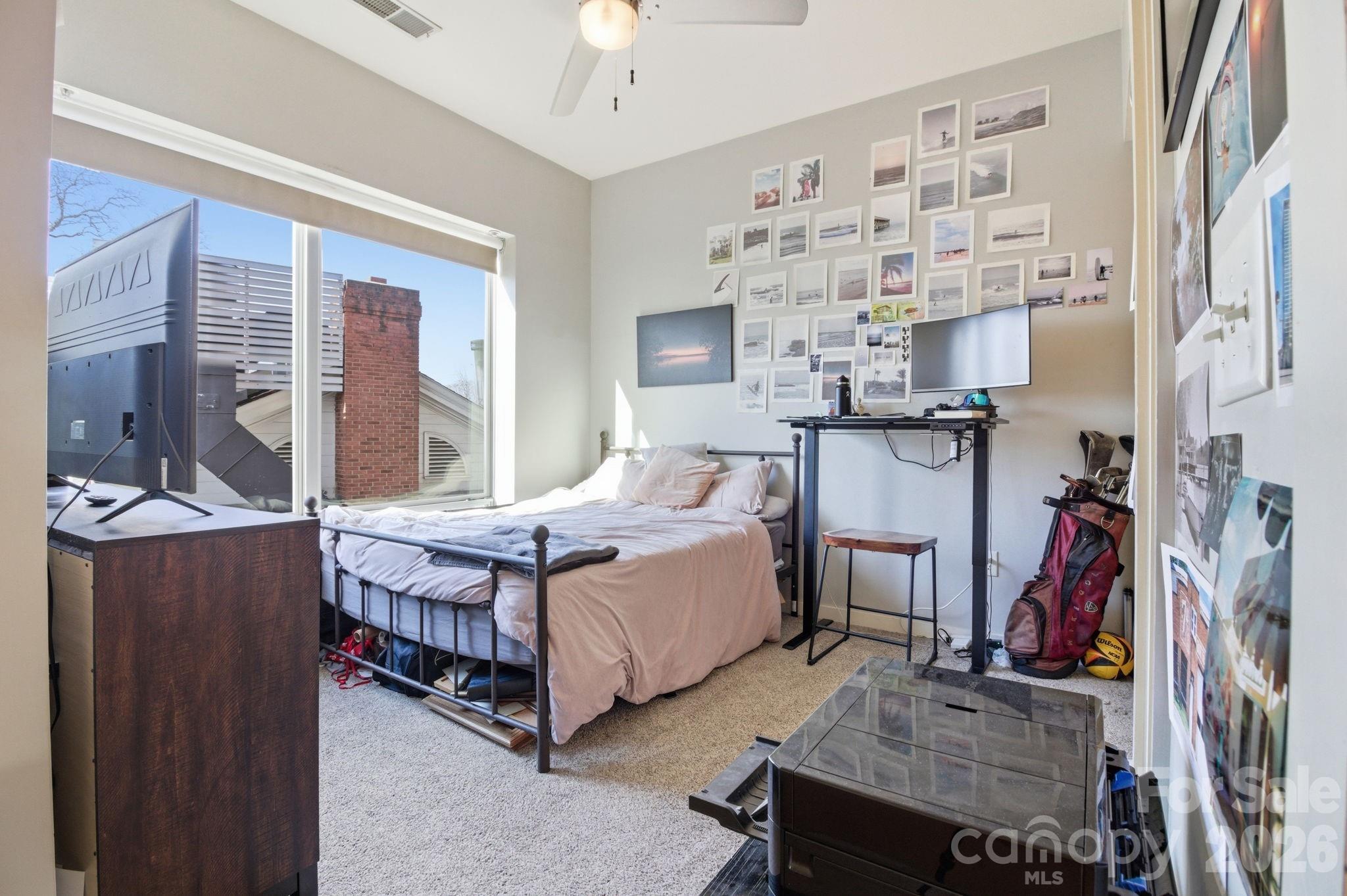 2116 McClintock Road, Unit 123 Charlotte, NC 28205 - Photo 14 of 28 a bed room with a bed and a chair