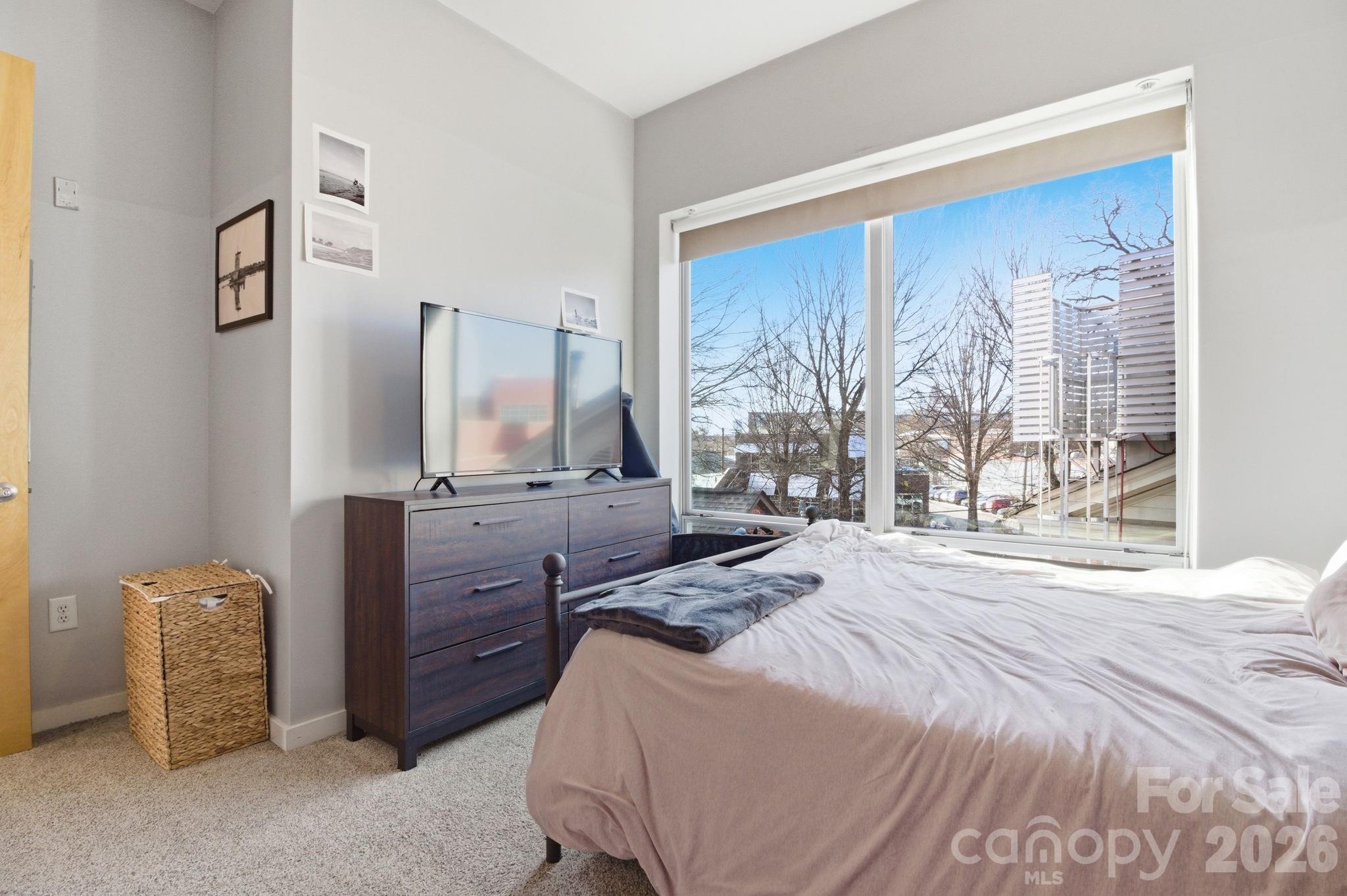 2116 McClintock Road, Unit 123 Charlotte, NC 28205 - Photo 15 of 28 a bedroom with a bed and a dresser