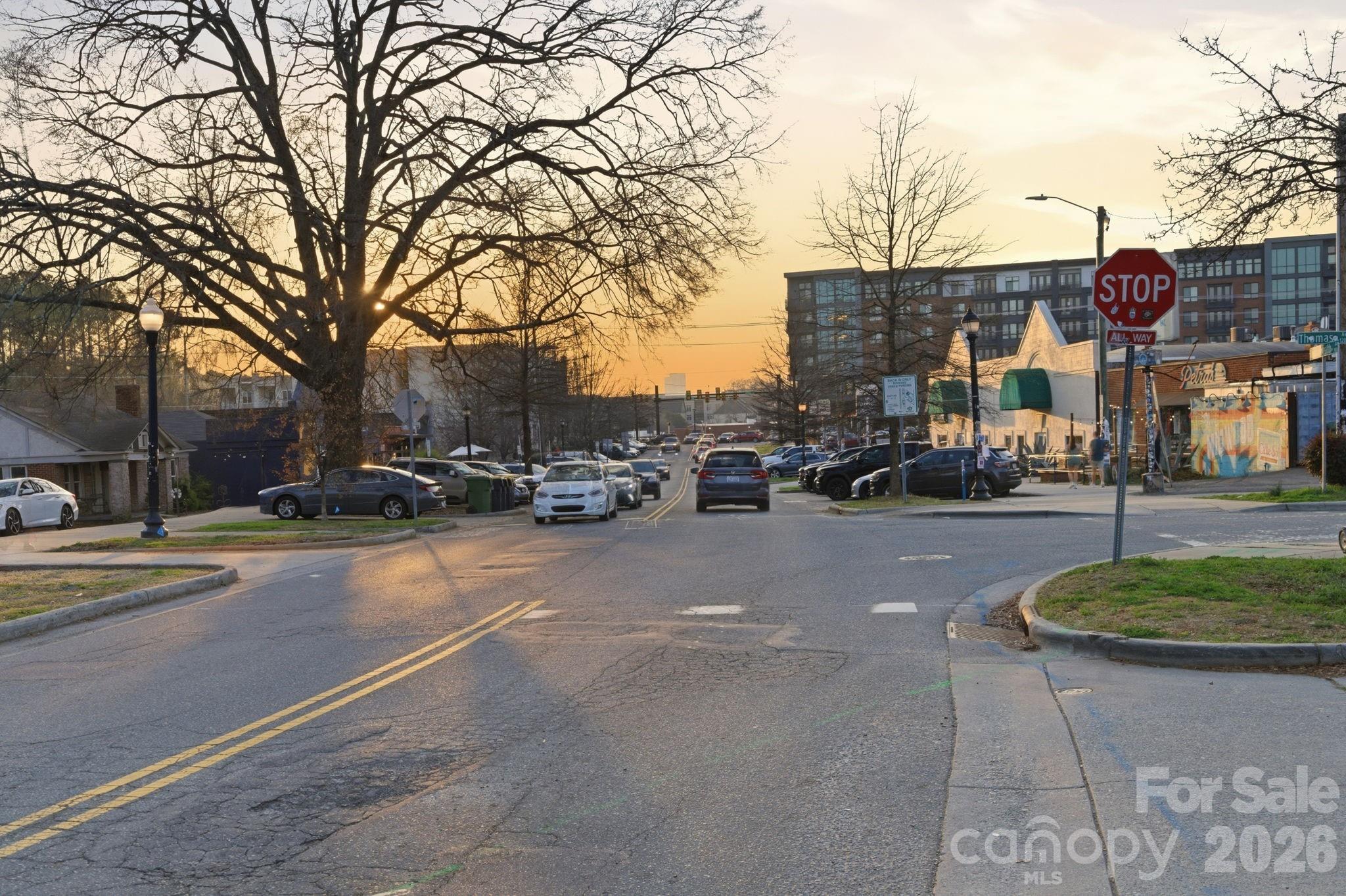 2116 McClintock Road, Unit 123 Charlotte, NC 28205 - Photo 18 of 28 a city street lined with buildings and cars