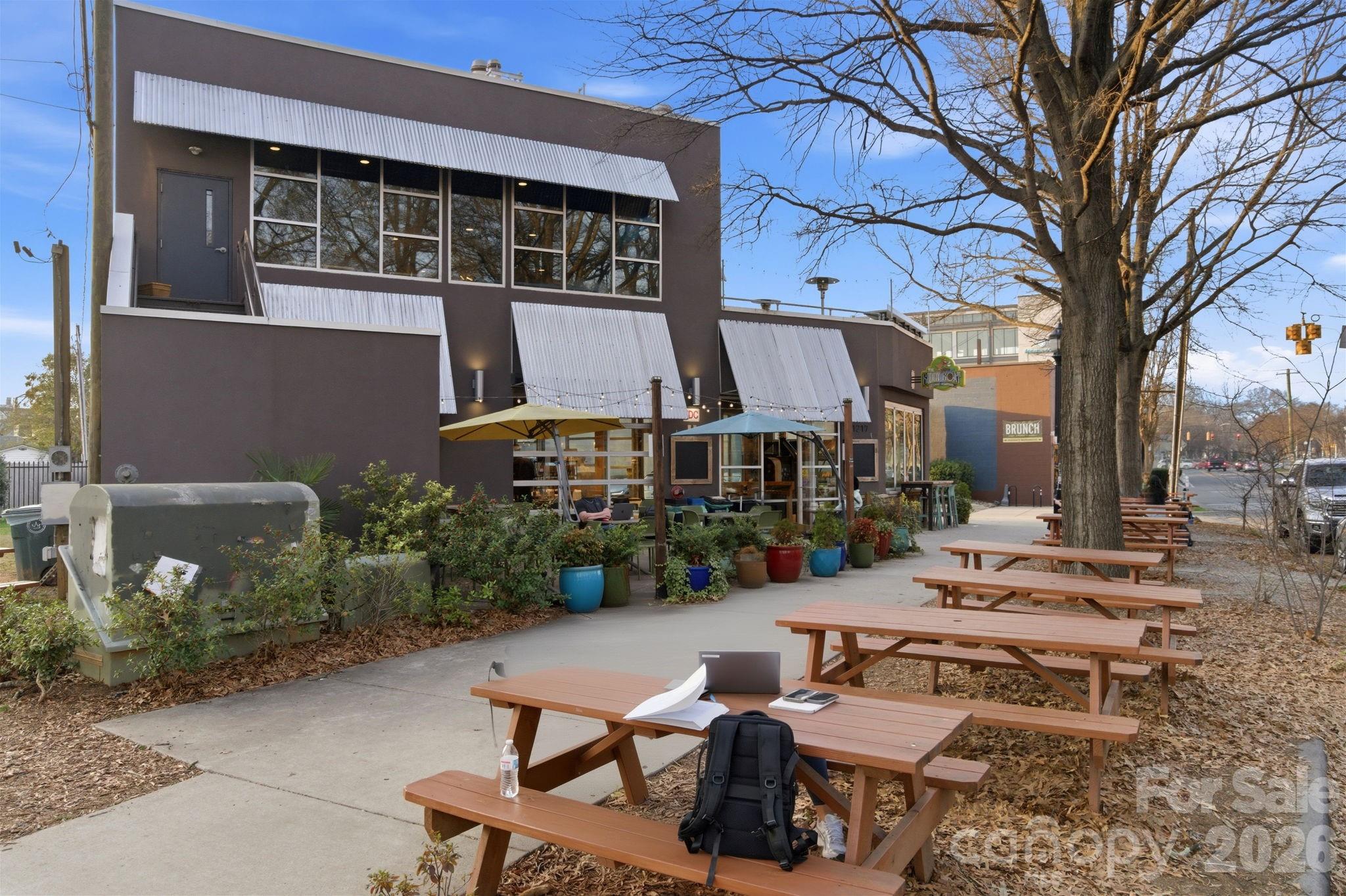 2116 McClintock Road, Unit 123 Charlotte, NC 28205 - Photo 22 of 28 a view of a patio with table and chairs with wooden fence and plants