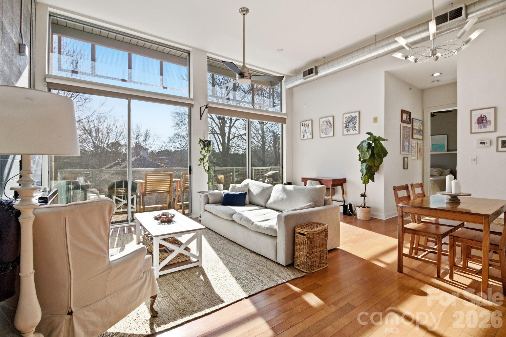 2116 McClintock Road, Unit 123 Charlotte, NC 28205 - Photo 3 of 28 a living room with fireplace furniture and a large window