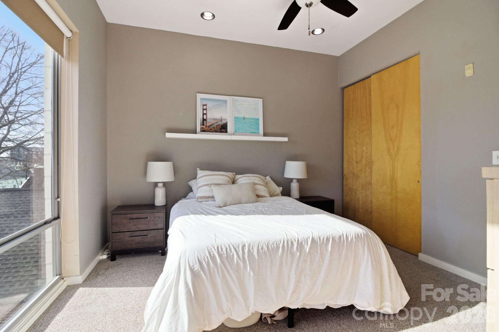 2116 McClintock Road, Unit 123 Charlotte, NC 28205 - Photo 10 of 28 a bedroom with a bed and a painting on the wall
