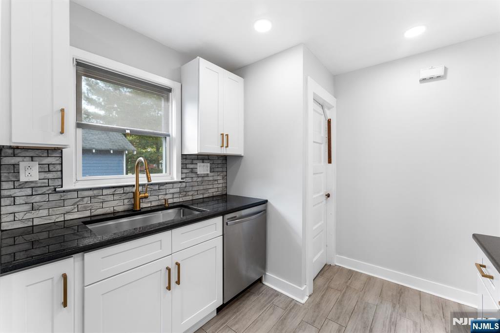 177 East Pierrepont Avenue Rutherford, NJ 07070 - Photo 17 of 27 a kitchen with granite countertop white cabinets and a sink