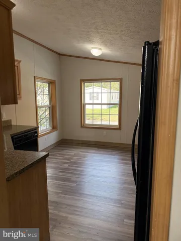 a view of a room with wooden floor and a window