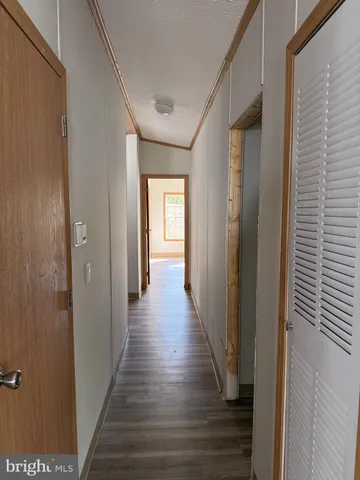 a view of a hallway with wooden floor