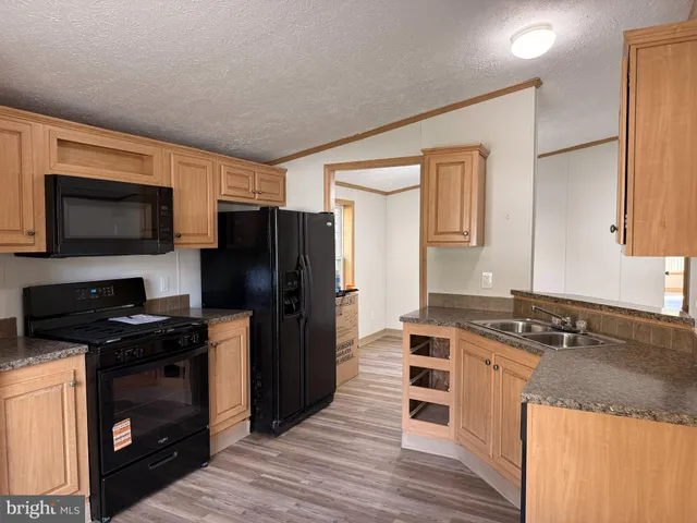 a kitchen with a stove a sink and a refrigerator