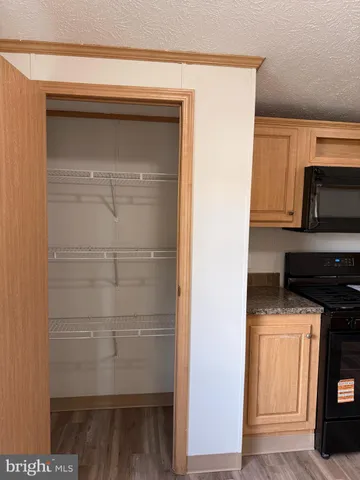 a kitchen with a refrigerator and a stove