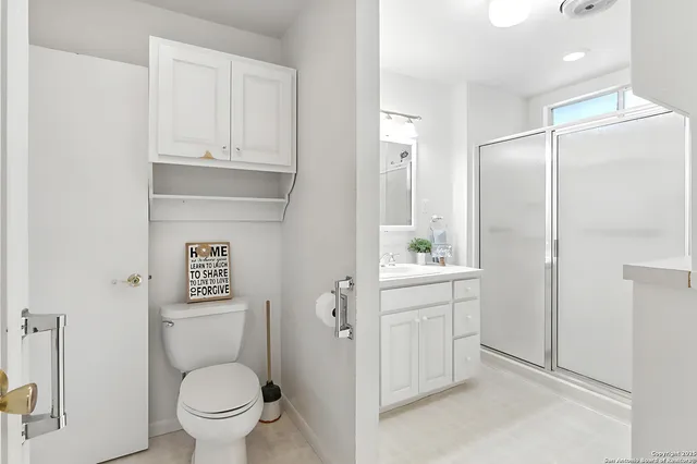 a bathroom with a toilet sink and shower