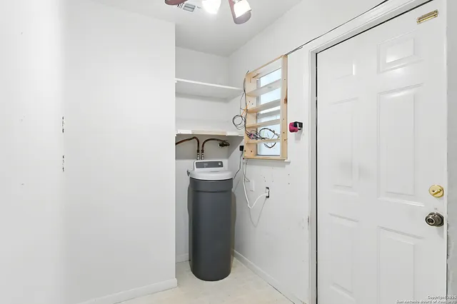 a room with a refrigerator and a window