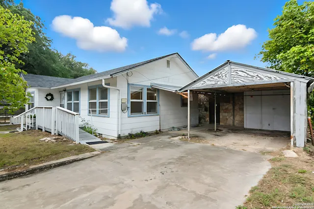 a view of a house with pool and garden