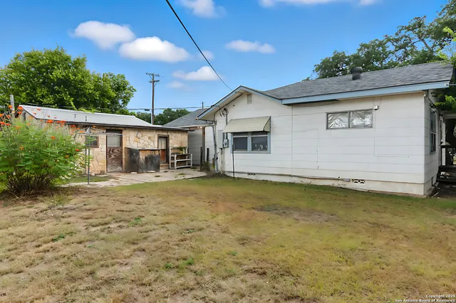 a palm tree sitting in front of a house with yard