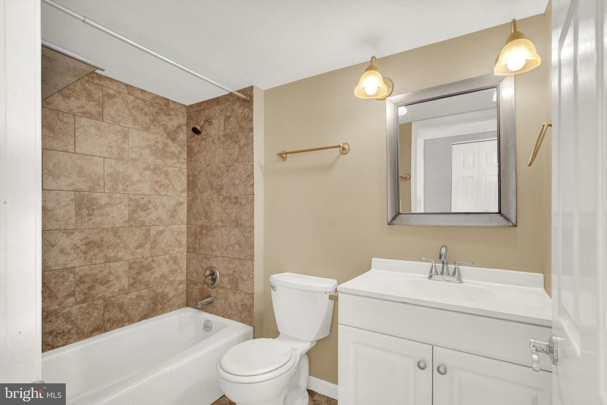 6 Storeys Court Baltimore, MD 21236 - Photo 22 of 27 a bathroom with a granite countertop sink a toilet and a bathtub