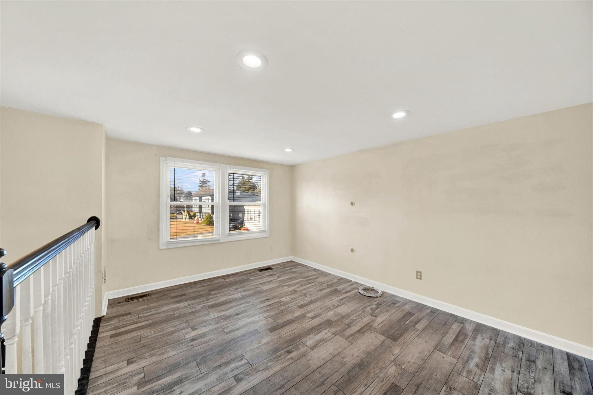 6 Storeys Court Baltimore, MD 21236 - Photo 4 of 27 an empty room with wooden floor and window