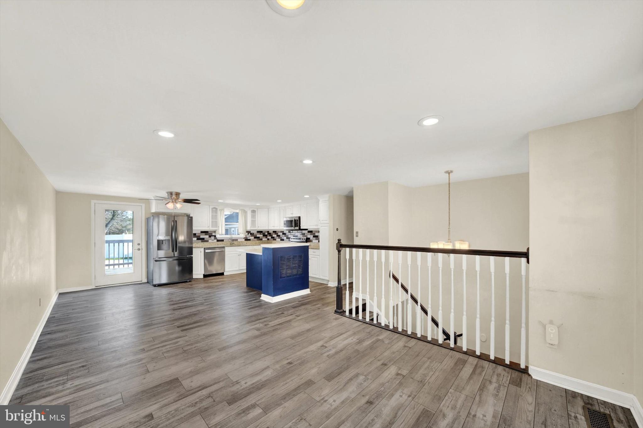 6 Storeys Court Baltimore, MD 21236 - Photo 5 of 27 a view of a kitchen with kitchen island stainless steel appliances wooden floor and window