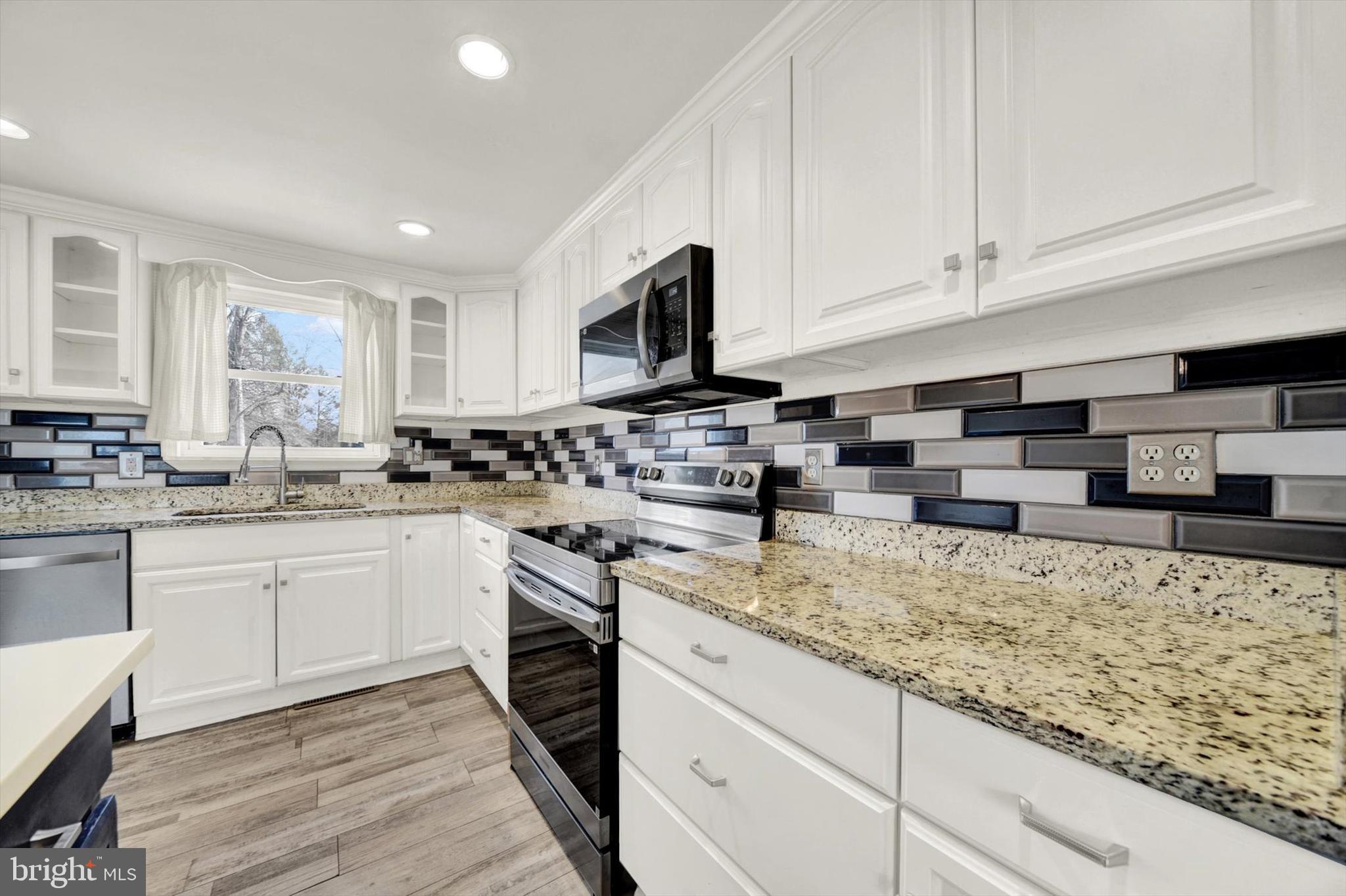 6 Storeys Court Baltimore, MD 21236 - Photo 8 of 27 a kitchen with granite countertop sink stainless steel appliances and window