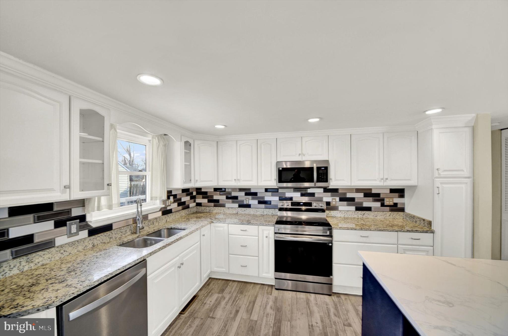 6 Storeys Court Baltimore, MD 21236 - Photo 9 of 27 a kitchen with a sink stove and cabinets
