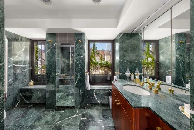 a bathroom with sink shower and mirror