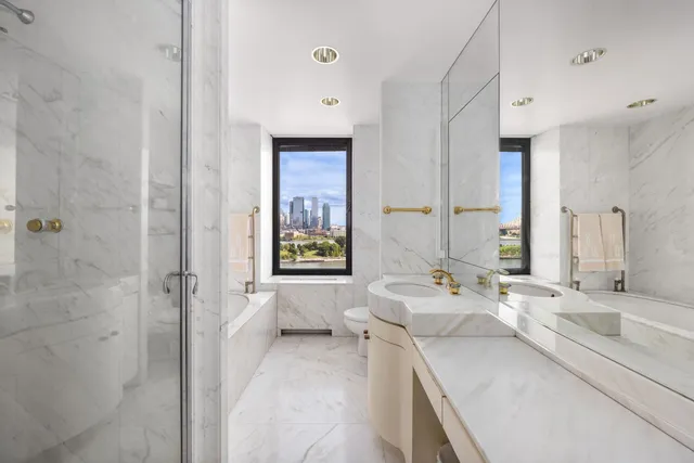 a en suite bathroom with a granite countertop sink and a mirror
