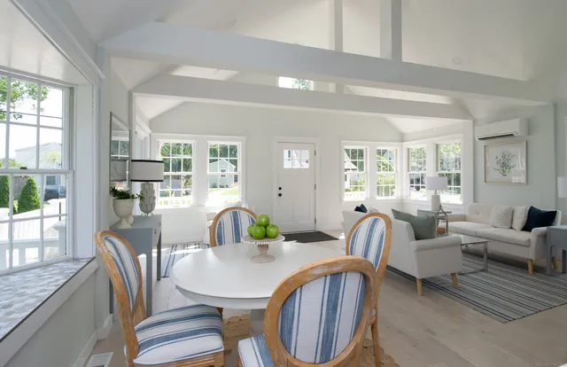 a living room with furniture a table and wooden floor
