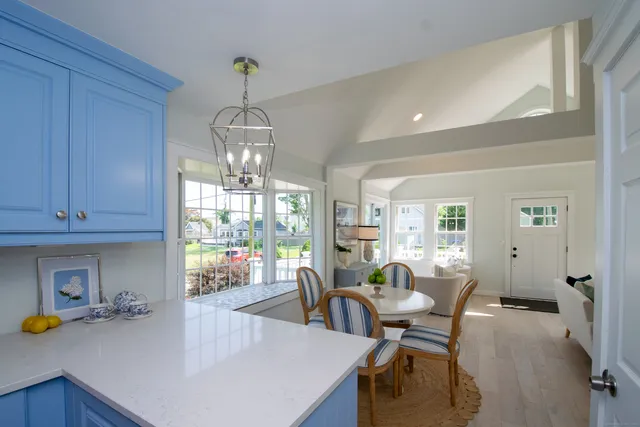 a view of a dining room with furniture and a window