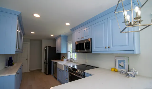 a kitchen with a refrigerator and a stove top oven