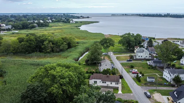 an aerial view of a house with a garden and lake view