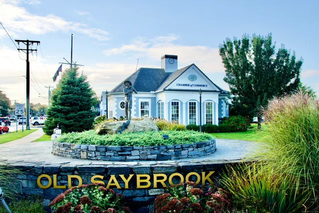 a wooden bench sitting in front of a building