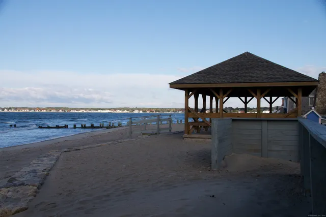 a view of a building and a car parked on the road