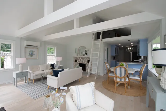 a living room with furniture a fireplace and a table