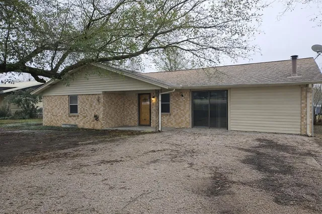 a house that has a tree in front of it