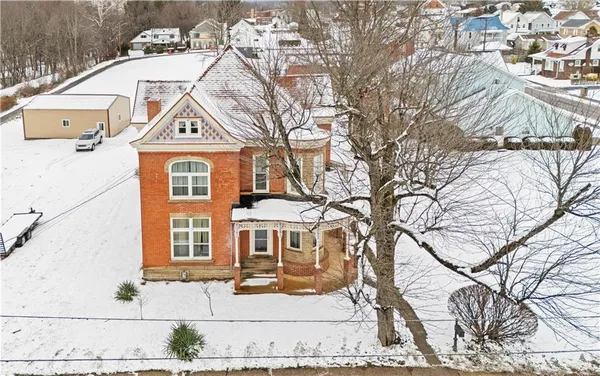 a view of a brick house with a yard