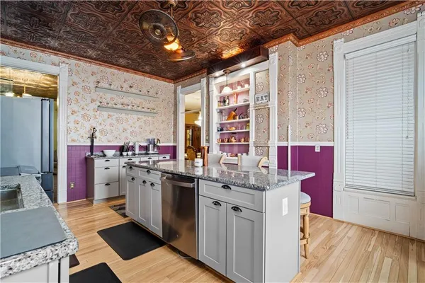a kitchen with stainless steel appliances granite countertop a refrigerator and a stove
