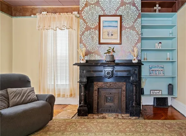 a living room with furniture a fireplace and a chandelier