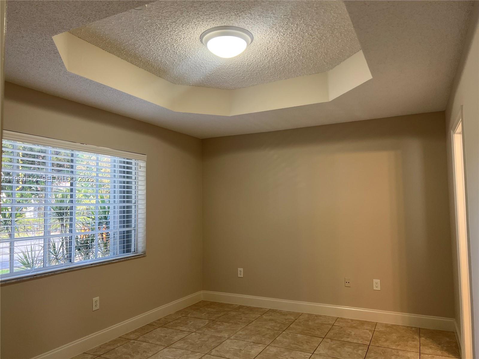 14225 Southwest 149th Avenue, Unit 14225 Miami, FL 33196 - Photo 12 of 19 an empty room with a empty space and windows