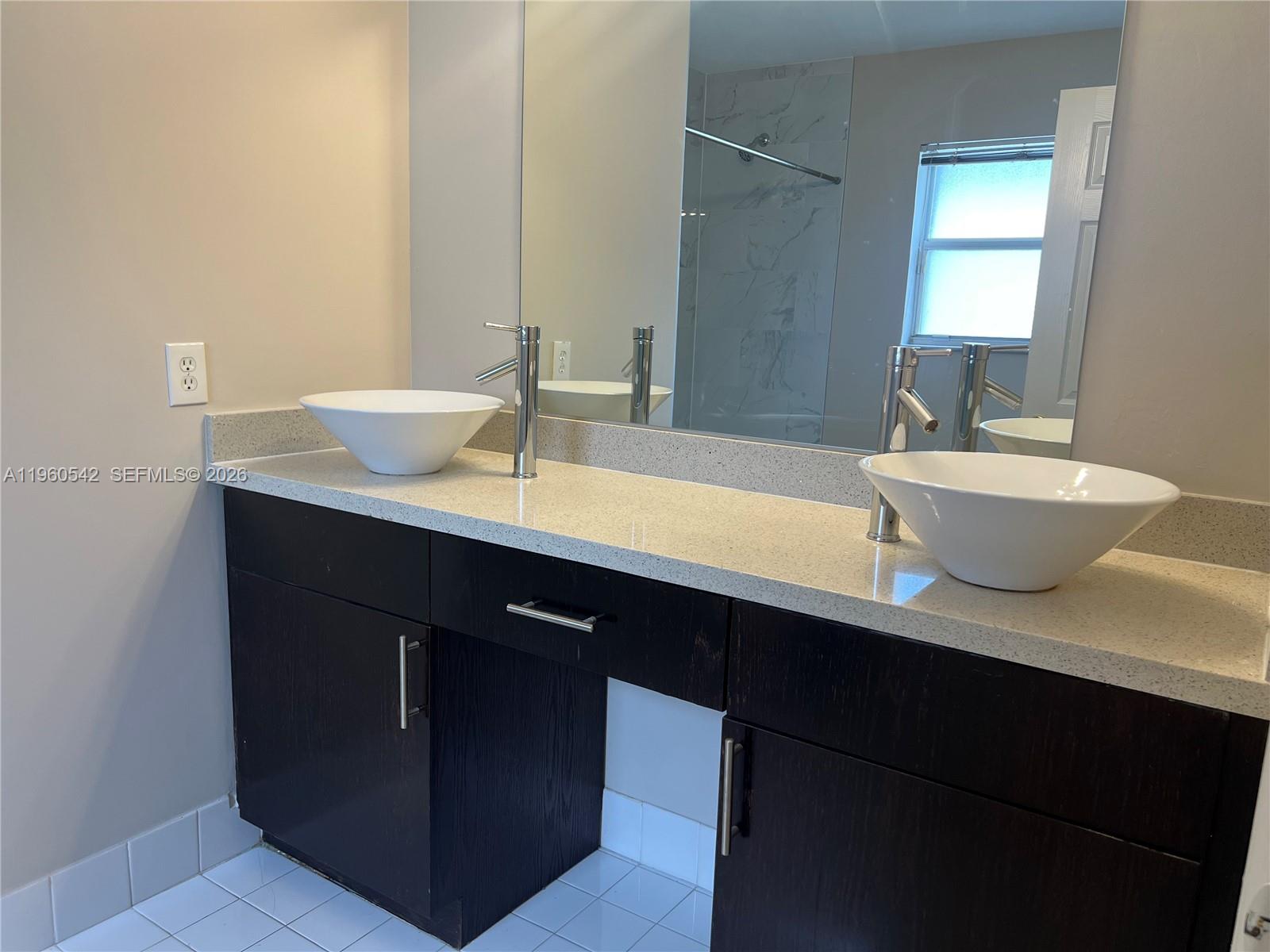 14225 Southwest 149th Avenue, Unit 14225 Miami, FL 33196 - Photo 14 of 19 a bathroom with a double vanity sink and a mirror