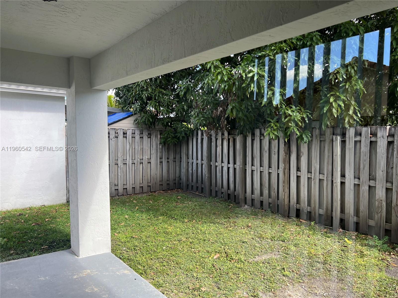 14225 Southwest 149th Avenue, Unit 14225 Miami, FL 33196 - Photo 17 of 19 a backyard of a house with green space