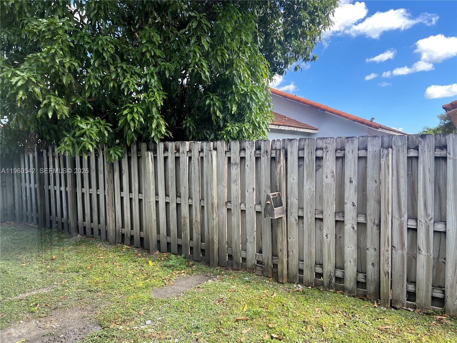 14225 Southwest 149th Avenue, Unit 14225 Miami, FL 33196 - Photo 19 of 19 a view of a backyard with wooden fence