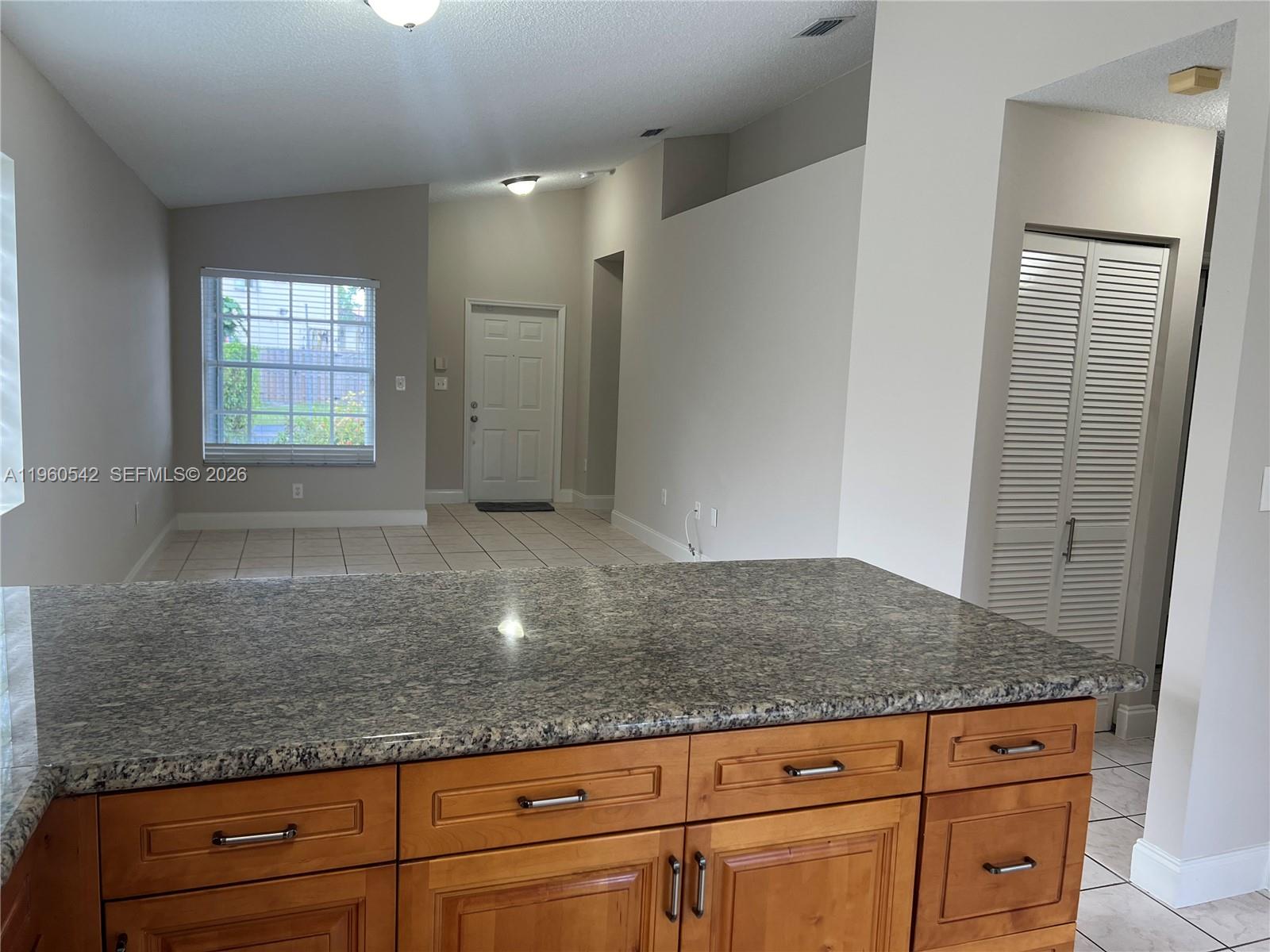 14225 Southwest 149th Avenue, Unit 14225 Miami, FL 33196 - Photo 6 of 19 a kitchen with granite countertop a sink and a granite counter tops