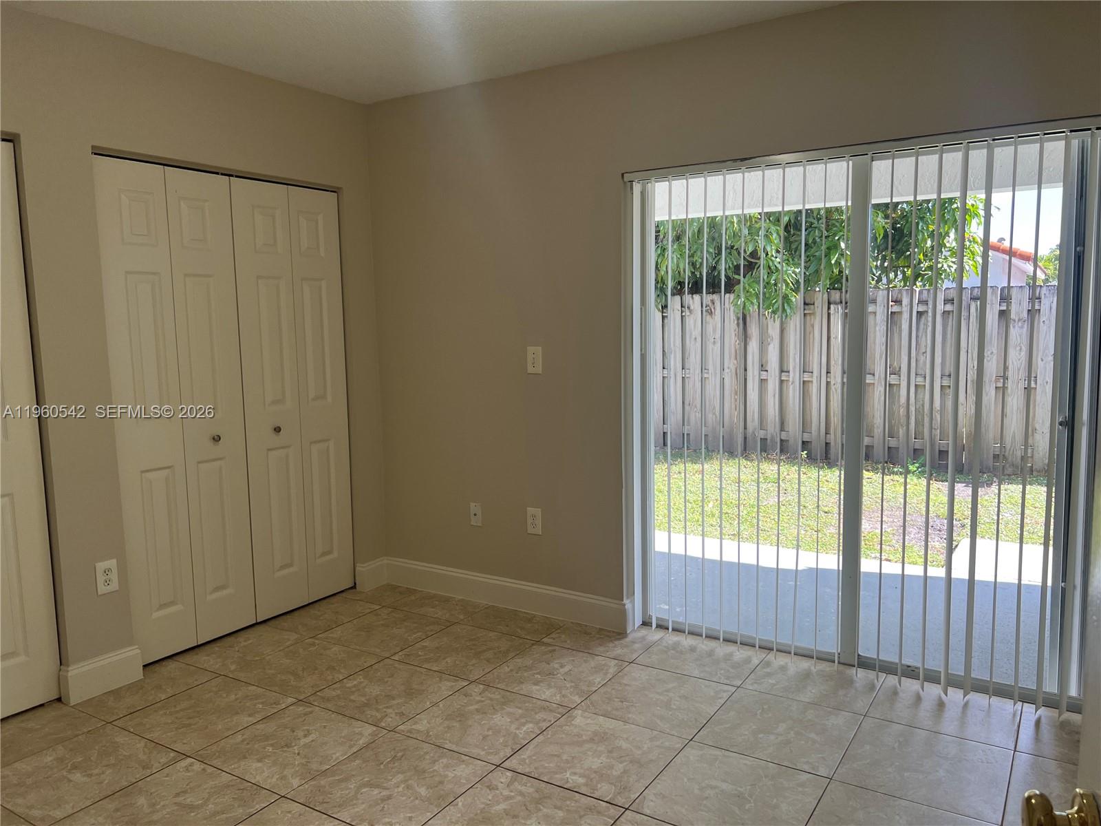14225 Southwest 149th Avenue, Unit 14225 Miami, FL 33196 - Photo 9 of 19 a view of an empty room with a window