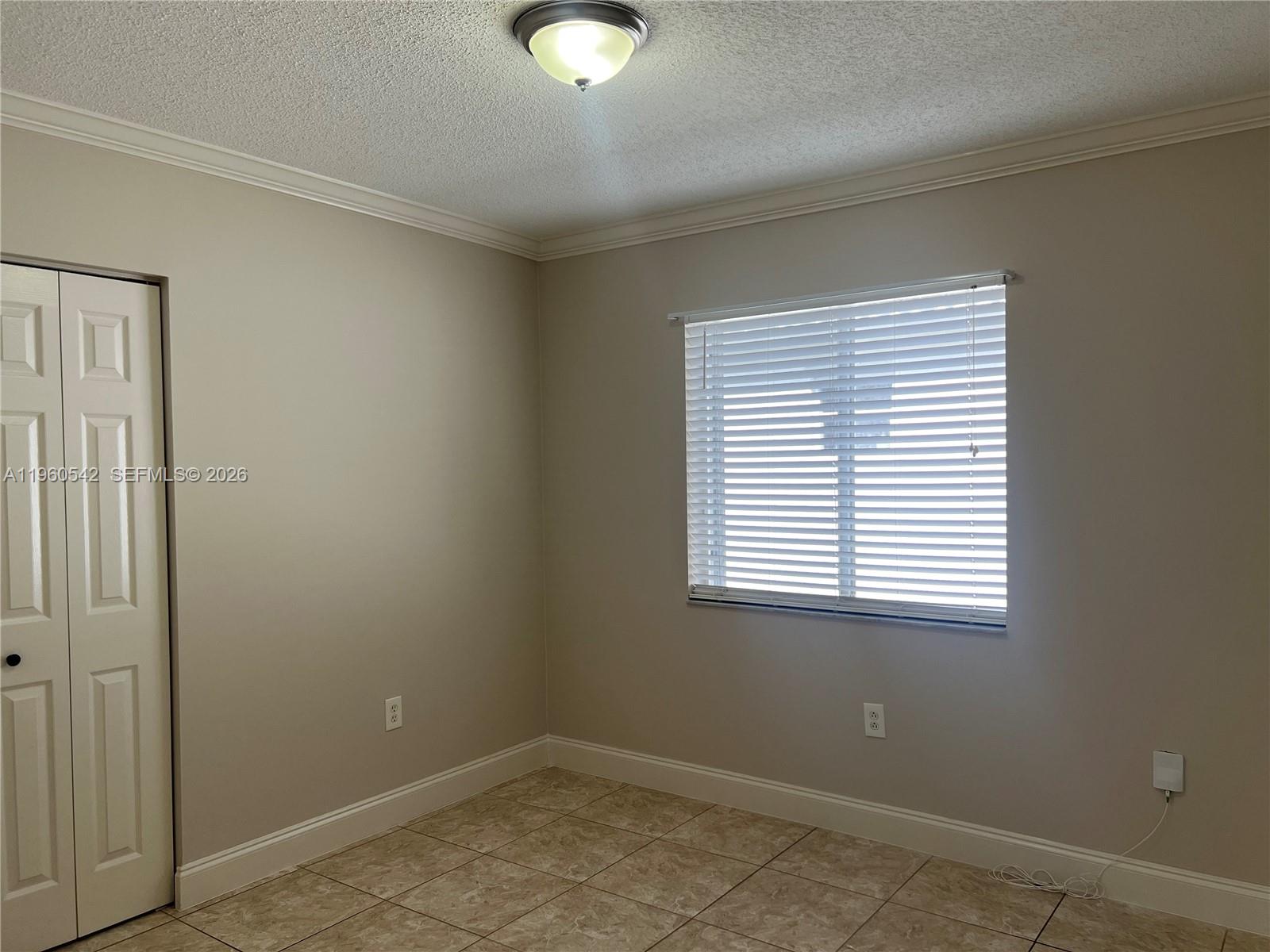14225 Southwest 149th Avenue, Unit 14225 Miami, FL 33196 - Photo 10 of 19 an empty room with a window