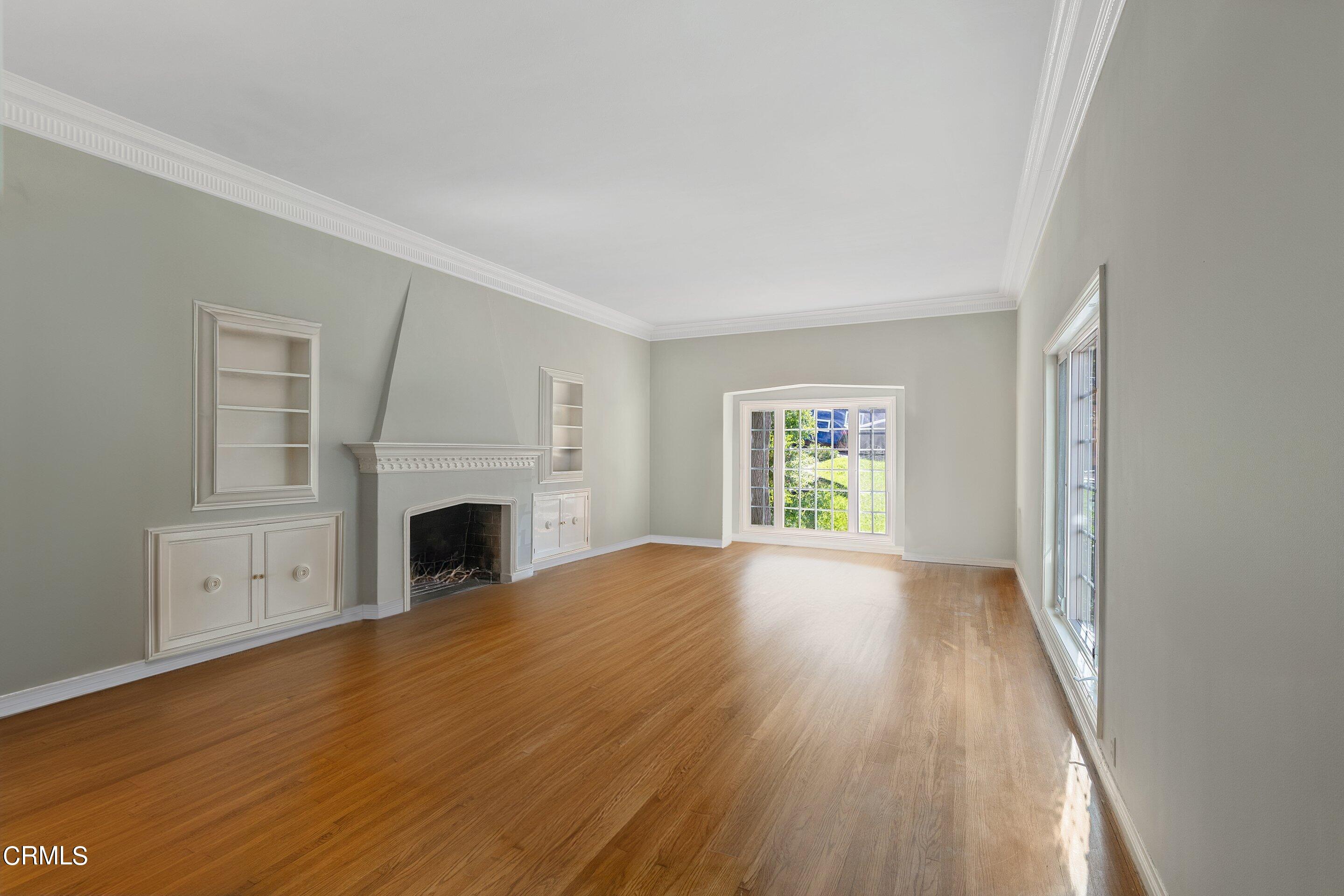 1637 Valley View Road Glendale, CA 91202 - Photo 15 of 66 a view of empty room with fireplace and wooden floor