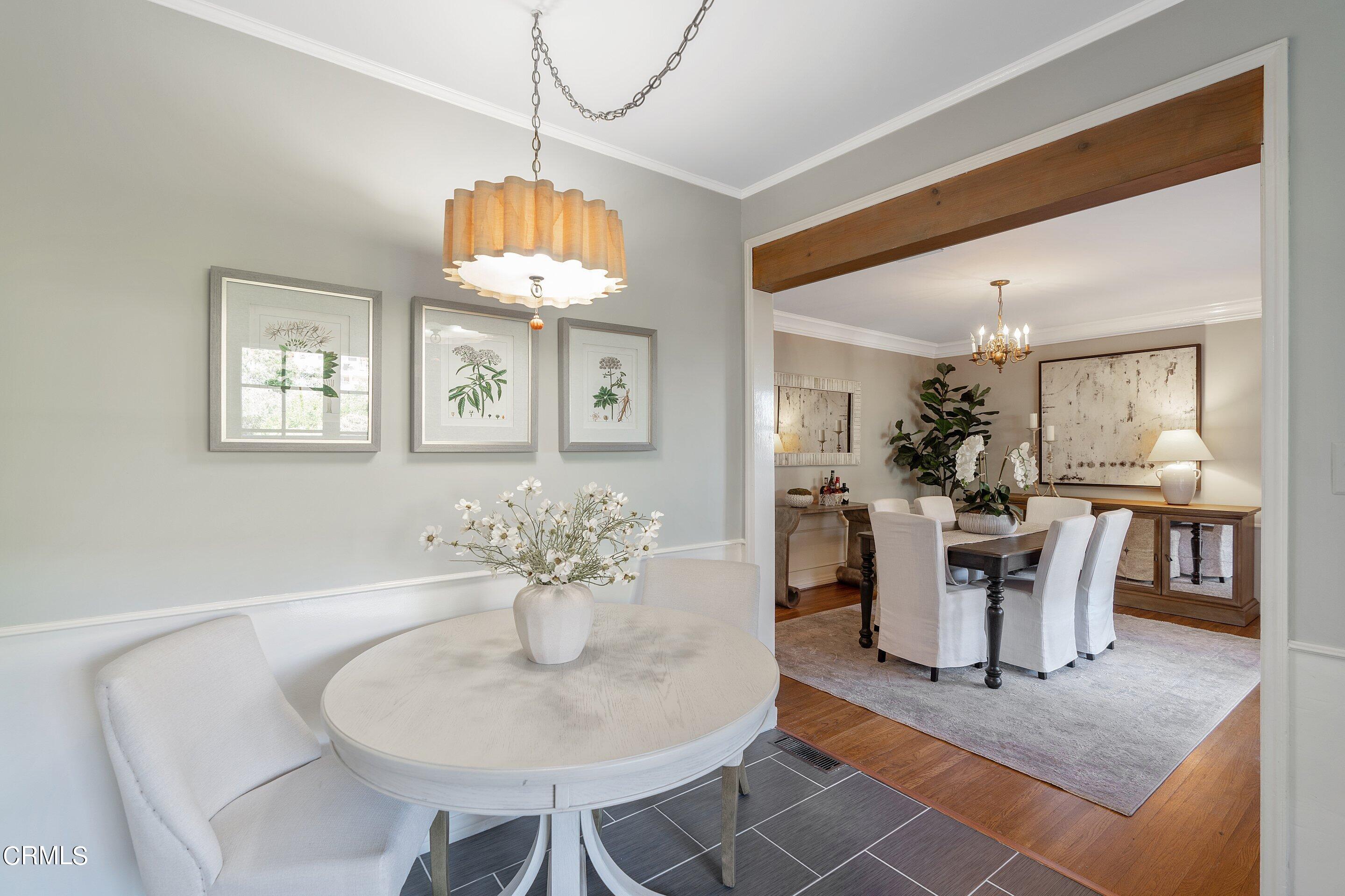 1637 Valley View Road Glendale, CA 91202 - Photo 27 of 66 a dining room with wooden floor a chandelier a glass table and chairs