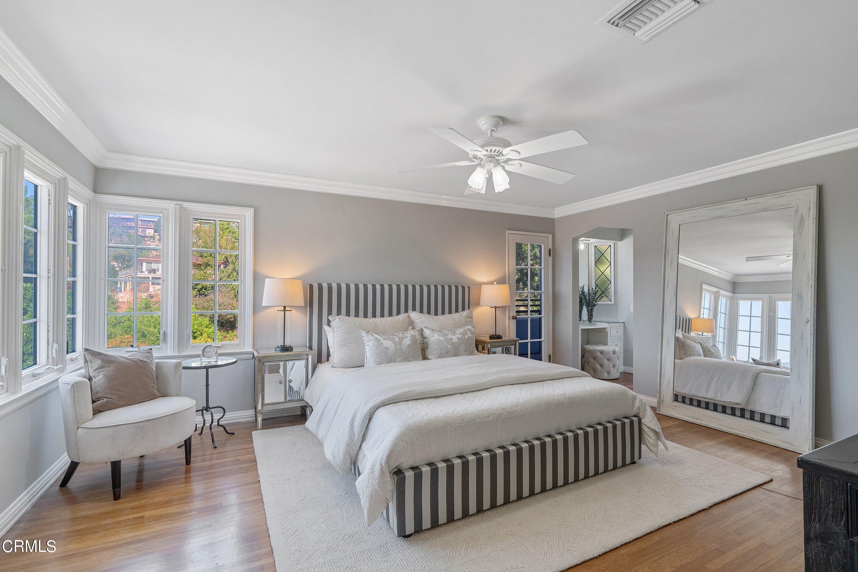 1637 Valley View Road Glendale, CA 91202 - Photo 35 of 66 a spacious bedroom with a large bed and a chandelier