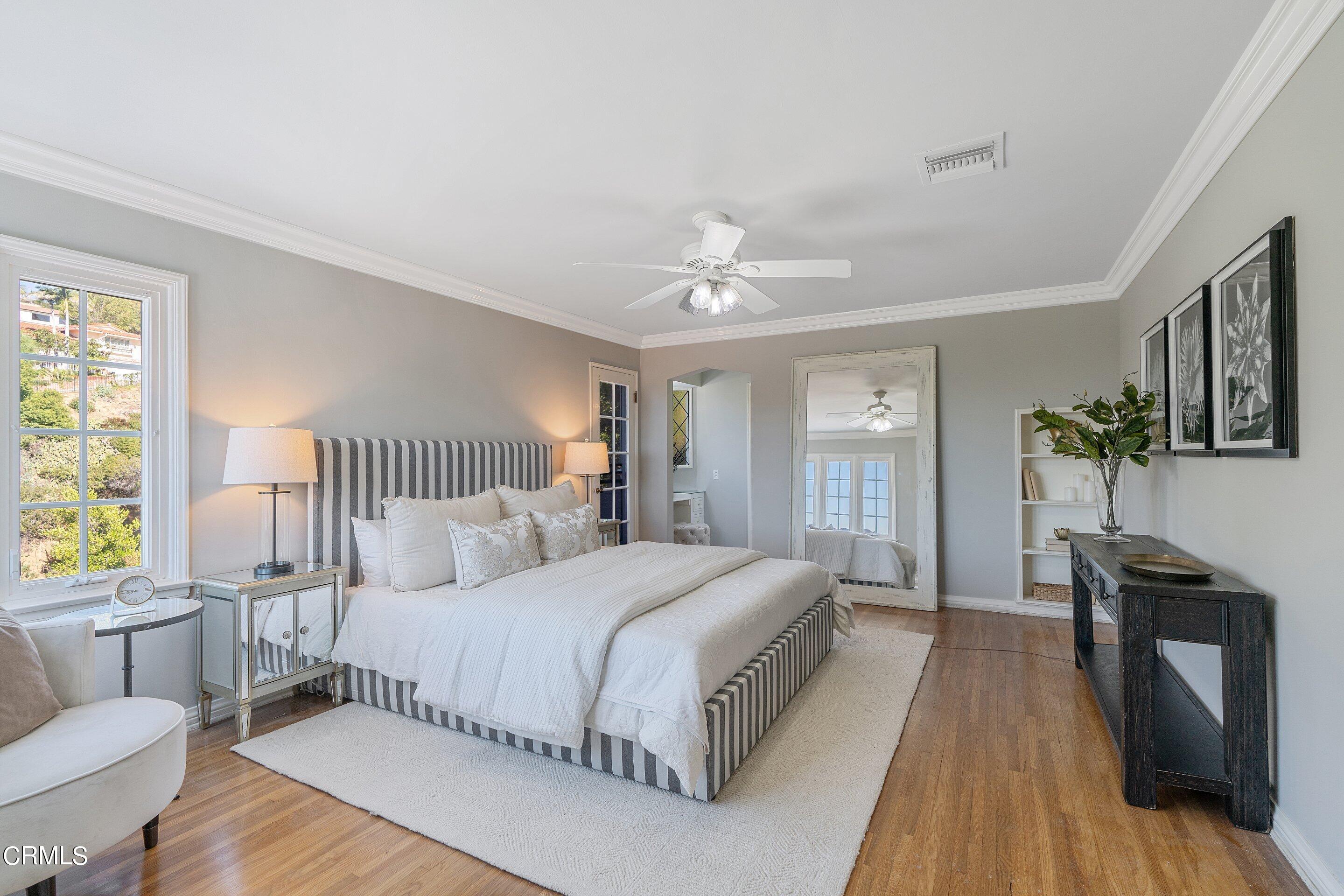 1637 Valley View Road Glendale, CA 91202 - Photo 36 of 66 a bedroom with a bed and a chandelier