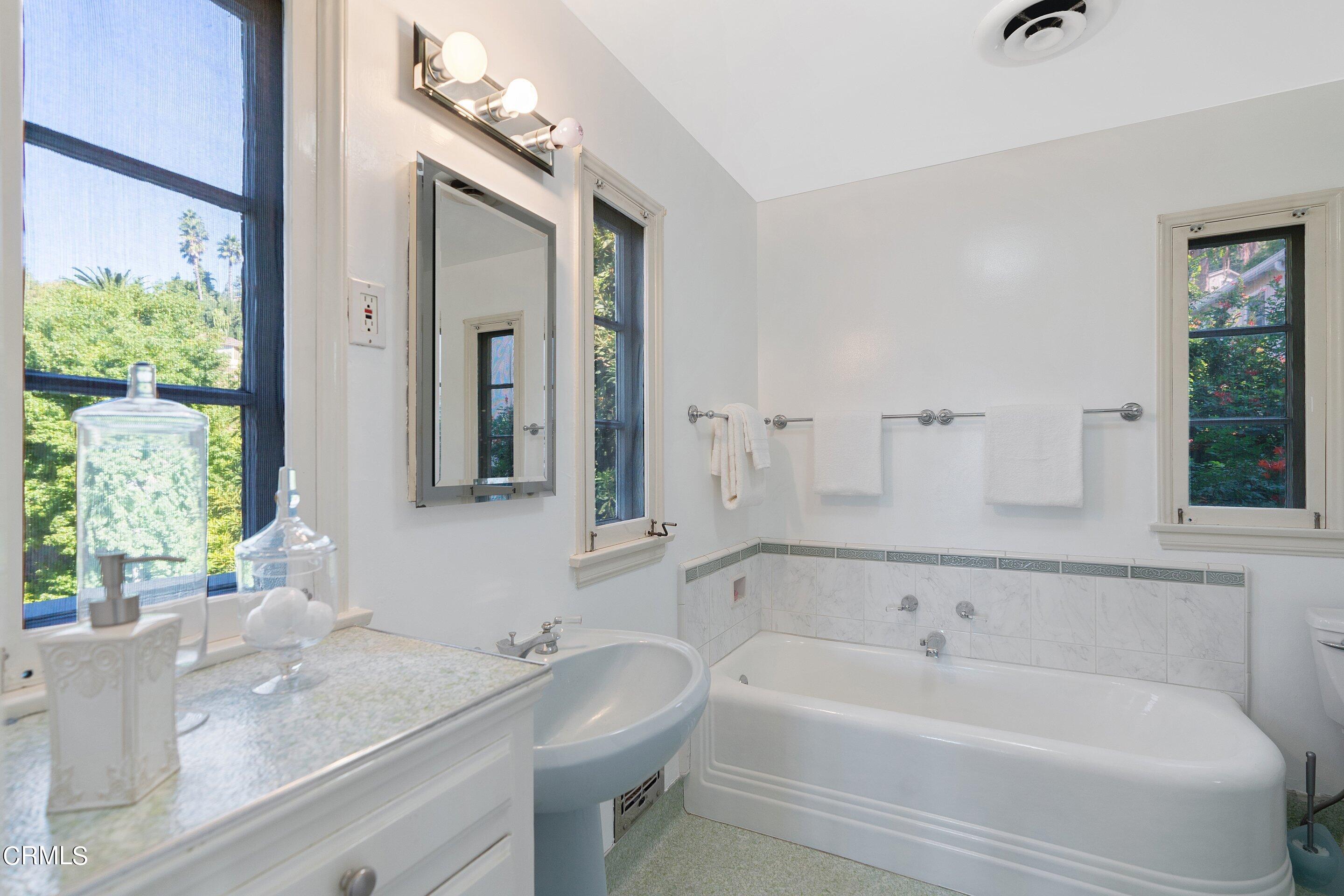 1637 Valley View Road Glendale, CA 91202 - Photo 44 of 66 a bathroom with a tub sink and mirror
