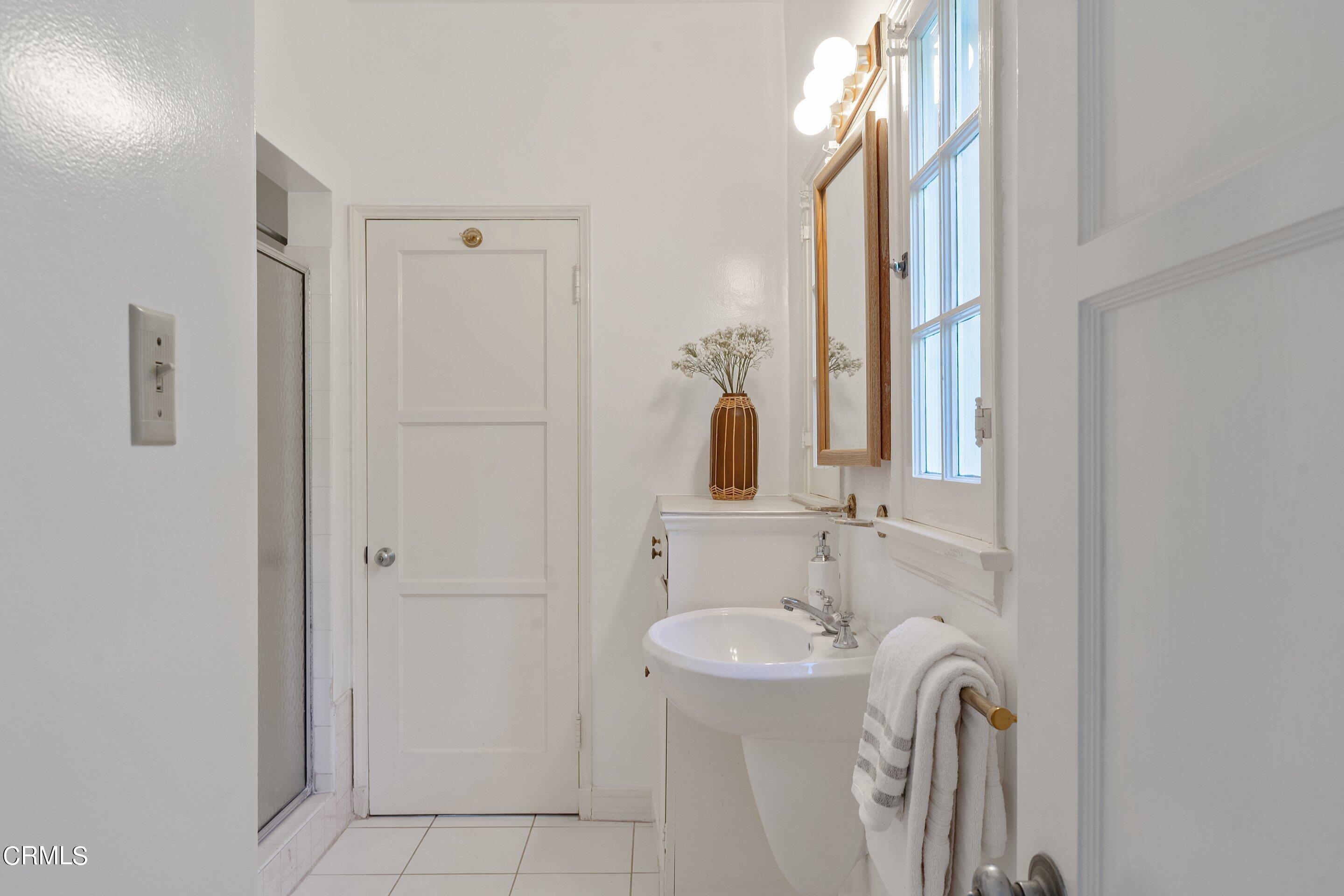 1637 Valley View Road Glendale, CA 91202 - Photo 50 of 66 a bathroom with a sink a toilet and a mirror