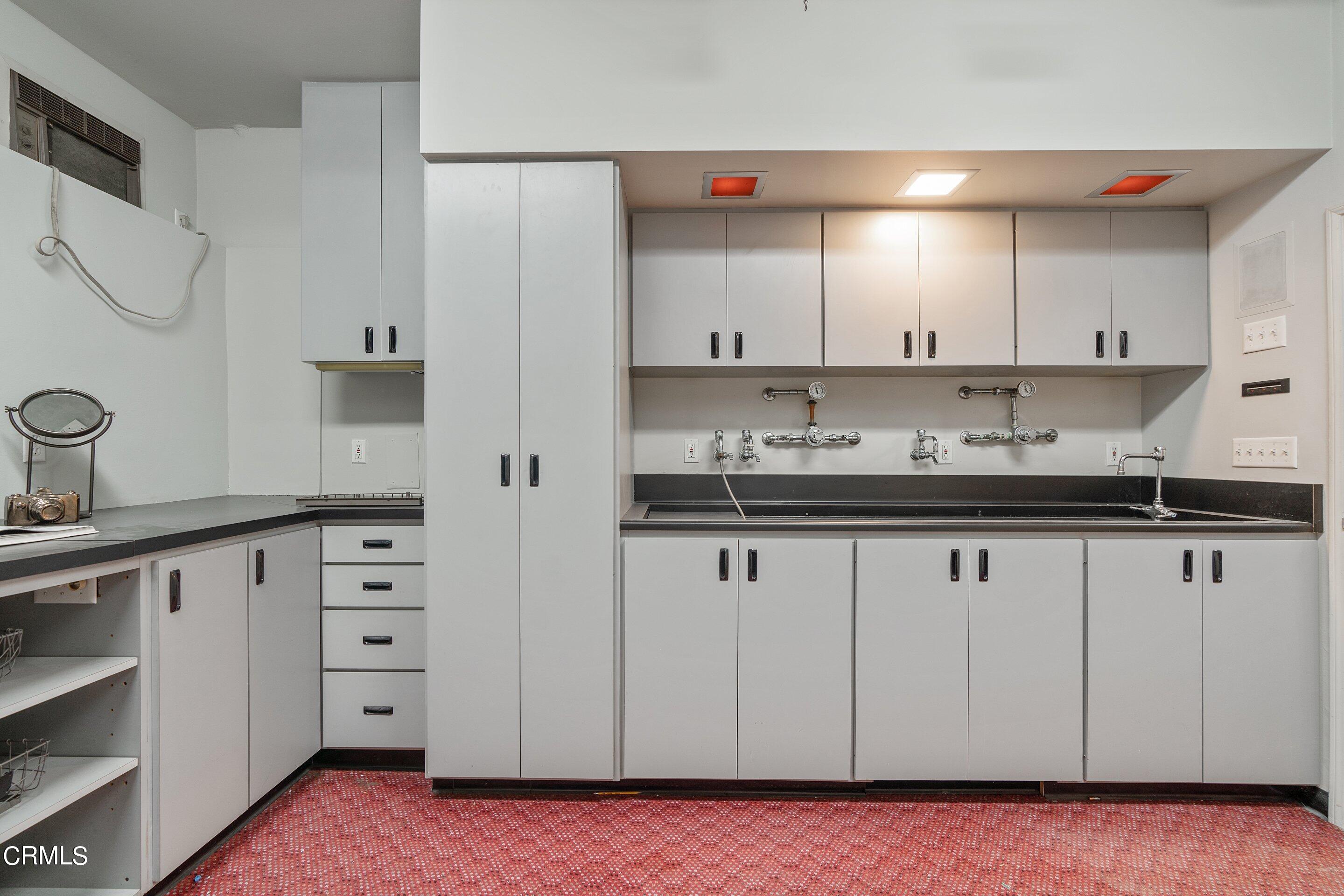 1637 Valley View Road Glendale, CA 91202 - Photo 57 of 66 a kitchen with granite countertop a sink cabinets and stainless steel appliances