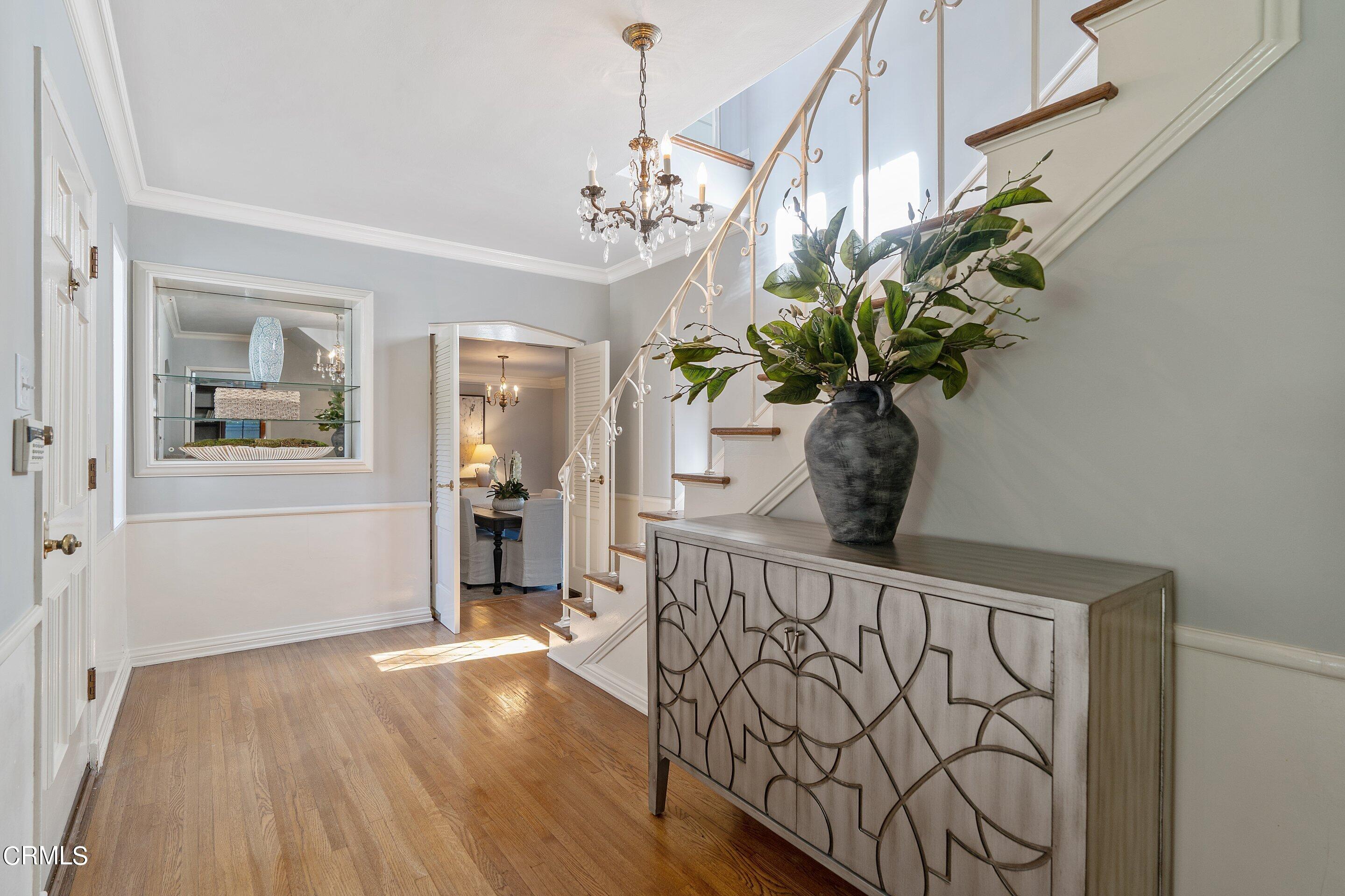 1637 Valley View Road Glendale, CA 91202 - Photo 9 of 66 a view of a hallway with wooden floor and a chandelier