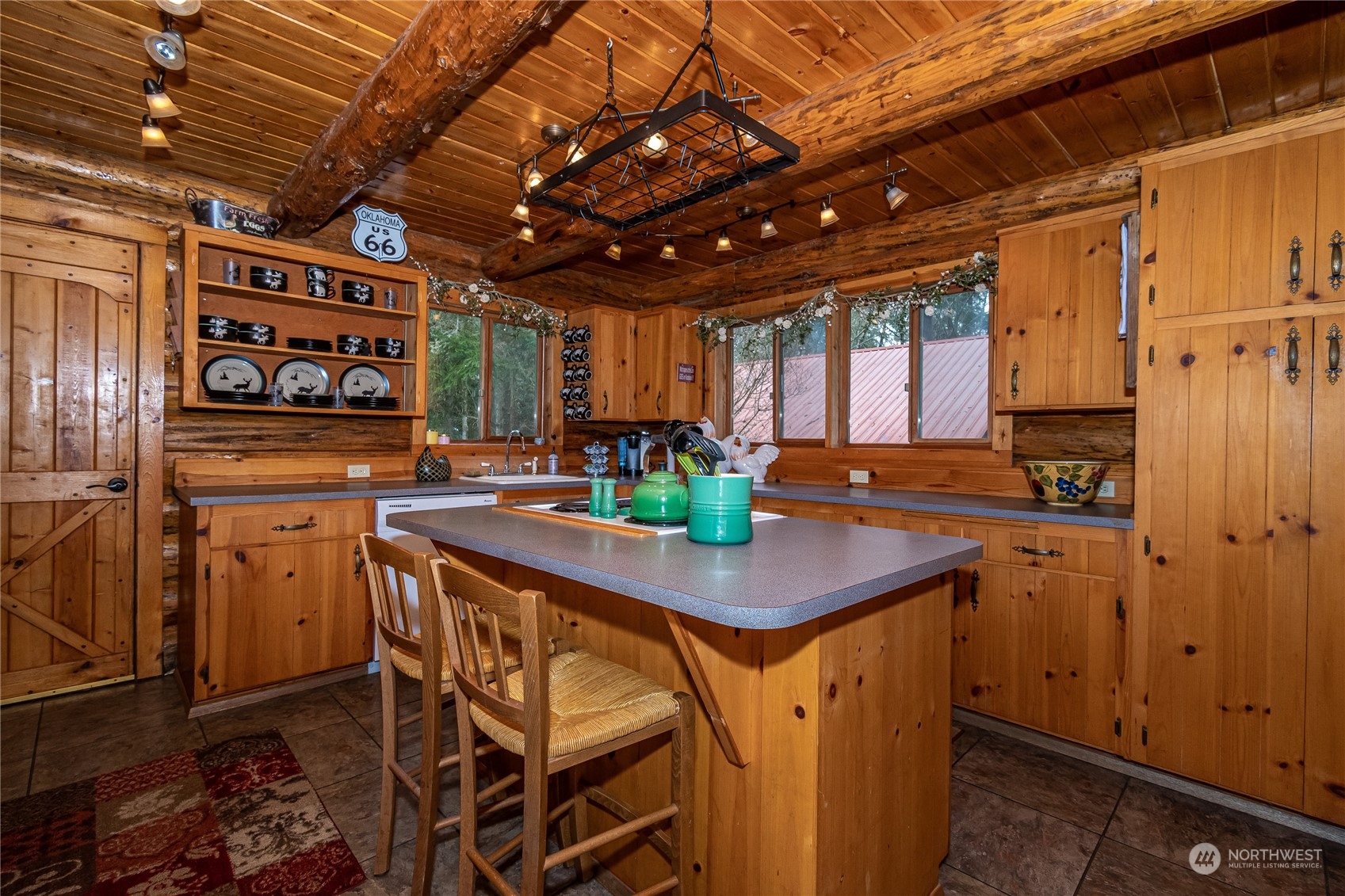 8526 Davenport Road Anderson Island, WA 98303 - Photo 14 of 31 a kitchen with stainless steel appliances granite countertop a sink a stove and wooden cabinets
