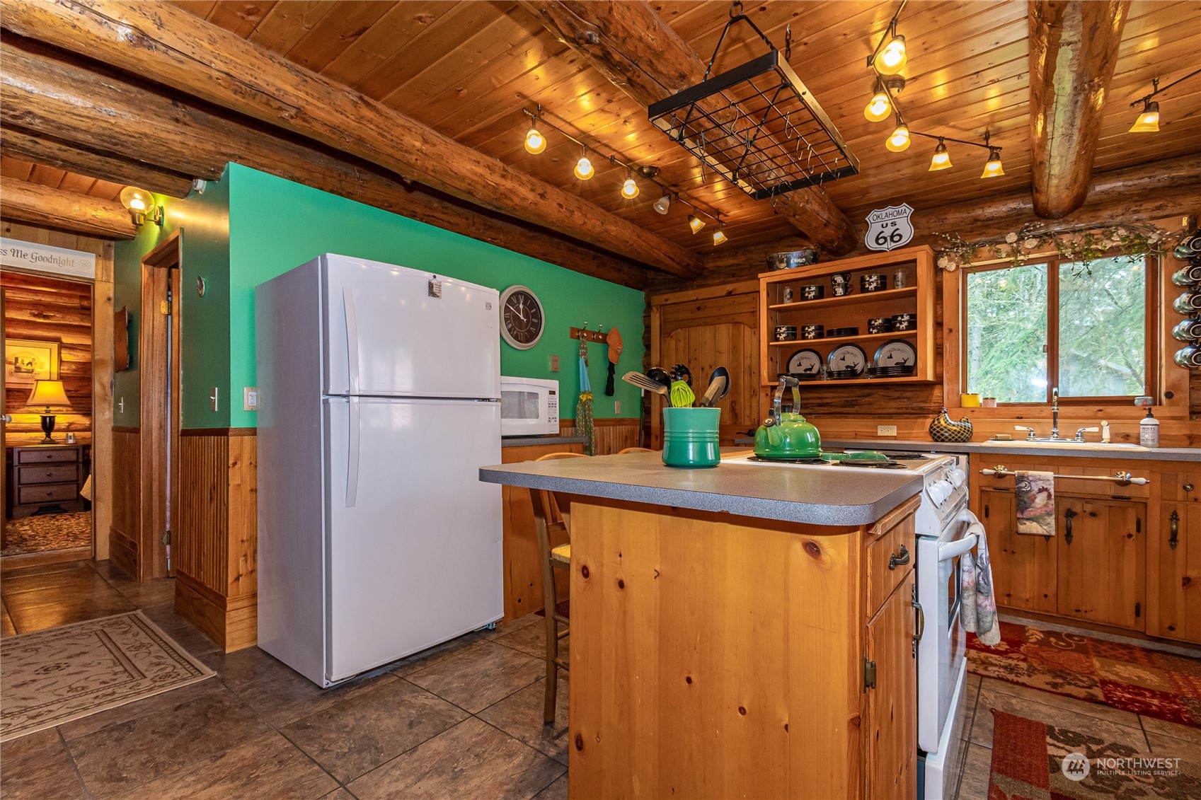8526 Davenport Road Anderson Island, WA 98303 - Photo 17 of 31 a kitchen with stainless steel appliances granite countertop a refrigerator and a sink
